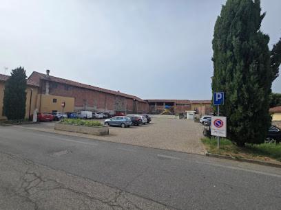 a parking lot with cars parked in front of a building at La Bolgora Guesthouse in Novara
