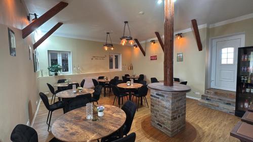a restaurant with tables and chairs and a fireplace at Statek Březina 