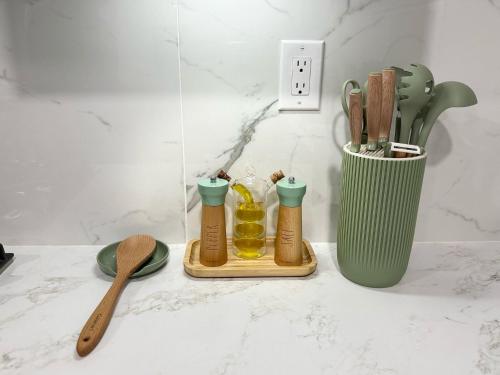 a kitchen counter with a cup of utensils and a bottle of honey at Dora's Haven Getaway-Cozy 1Bedroom with Boat or Camper Parking- Free in Mount Dora
