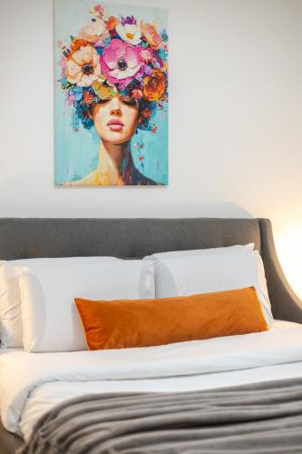 a painting of a woman with flowers on her head at Artful 3BR in Montreal Village in Montréal
