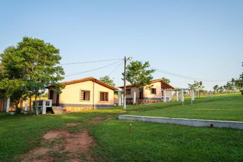 a row of houses in a field with a yard at Los Cantares in Piribebuy