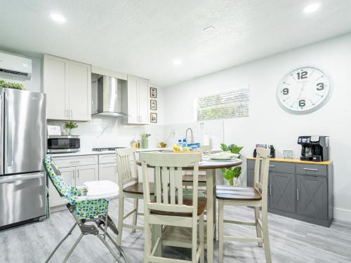 a kitchen with a table and chairs and a clock on the wall at Dora's Haven Getaway-Cozy 1Bedroom with Boat or Camper Parking- Free in Mount Dora