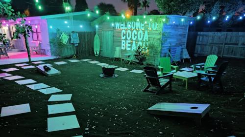 a stage with chairs and a table and lights at Steps to Beach & Downtown Fun in Cocoa Beach