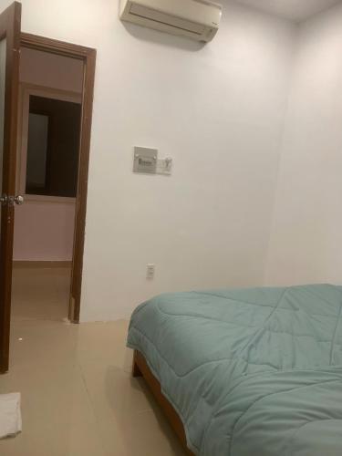 a bedroom with a bed and a window and a fan at Lunaria Maison - Thư Thái Homestay in Ho Chi Minh City