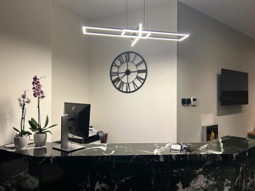 an office with a clock on the wall and a desk at Downtown Suites in Thessaloniki