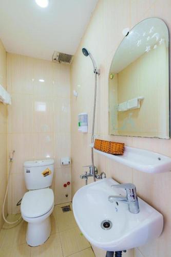 a bathroom with a toilet and a sink and a mirror at Lunaria Maison - Thư Thái Homestay in Ho Chi Minh City