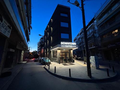 a building with a sign for a donut shop on a street at Downtown Suites in Thessaloniki