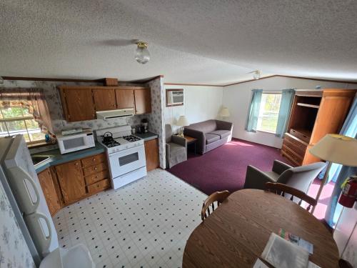 a small kitchen and living room with a table in it at Lake View Motel in Cooperstown