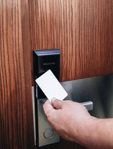 a person holding a piece of paper in a door at AS Hotel Ganja in Ganja