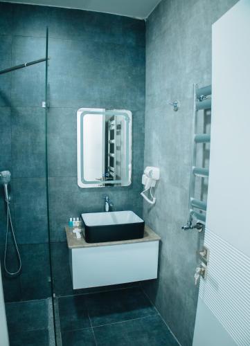 a bathroom with a sink and a mirror at AS Hotel Ganja in Ganja