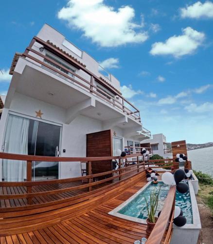 a balcony of a house with a swimming pool at Villa Orion in Arraial do Cabo