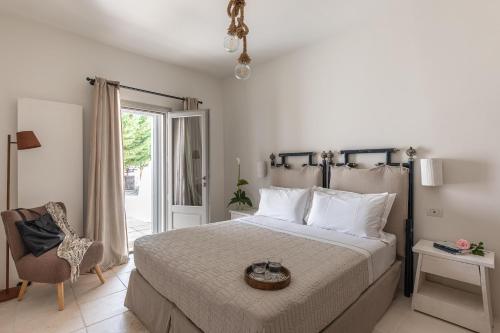 a bedroom with a bed and a chair and a window at Dimora Dei Semplici in Ostuni