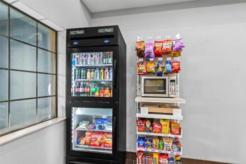 a refrigerator filled with lots of drinks and a microwave at Spark by Hilton Round Rock in Round Rock