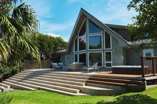 a house with a staircase leading up to a house at Monterey House by SANA in Tateyama