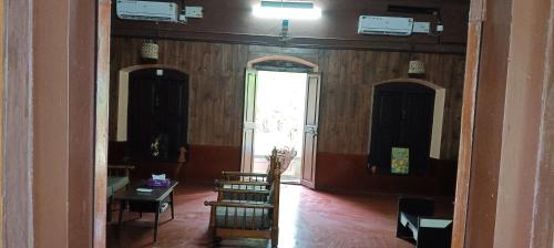 a hallway with a room with wood paneling and a door at Vintage Vista in Lakkidi