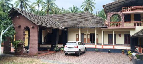 a car parked in front of a house at Vintage Vista in Lakkidi