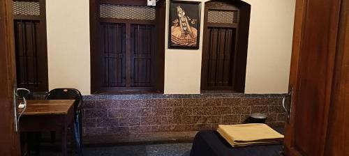 a pair of doors in a room with a table at Vintage Vista in Lakkidi