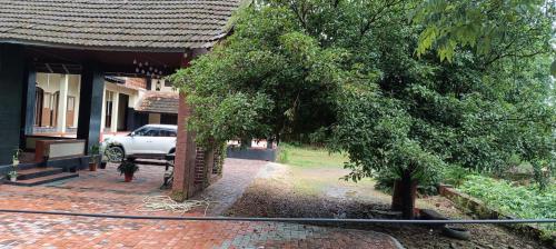 a dog is standing outside of a house at Vintage Vista in Lakkidi