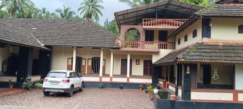 a white car parked in front of a house at Vintage Vista in Lakkidi