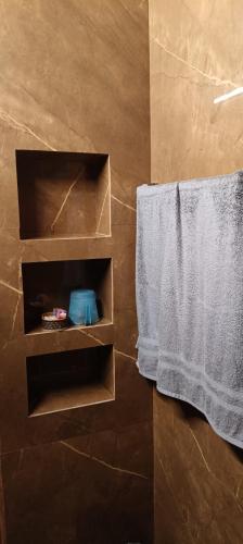a bathroom with a towel hanging on a wall at Vintage Vista in Lakkidi