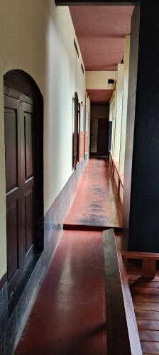 an empty hallway of a building with a door at Vintage Vista in Lakkidi