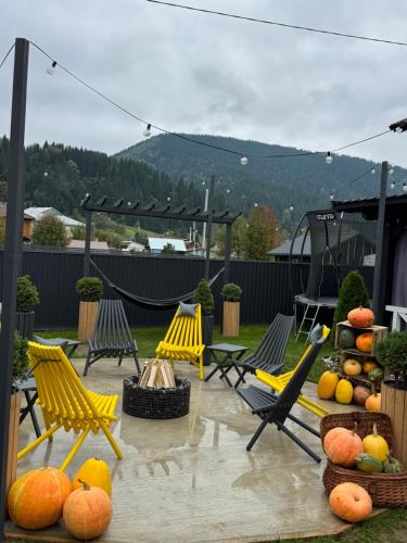 a group of yellow chairs and fruit on a patio at Weekend house in Verkhovyna