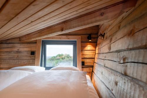 a bedroom with two beds and a window at Backyard Camps in Bjerkreim