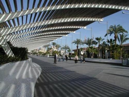 a group of people walking on a street with a building at Yovalu Con Balcon in Torrevieja