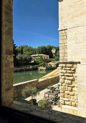 a view of a pool of water from a building at L'orto Delle Terme in Bagno Vignoni