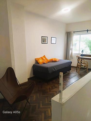 a bedroom with a bed and a chair and a desk at Montevideo Del Parque in Montevideo