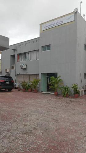 a building with a car parked in front of it at Hotel bougainvillea Victoria island in Lagos