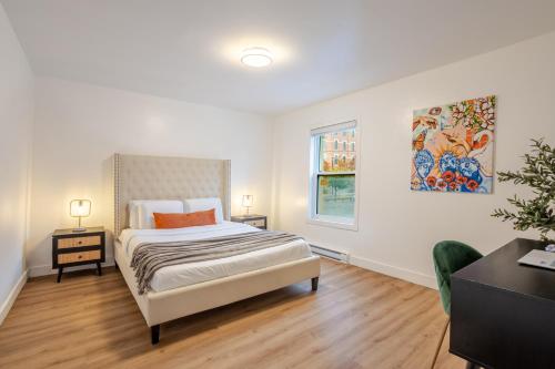a white bedroom with a bed and a window at Spacious 3BR in the heart of Village in Montréal