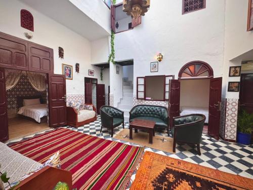 a living room with a bed and a rug at Dar SAAD in Rabat