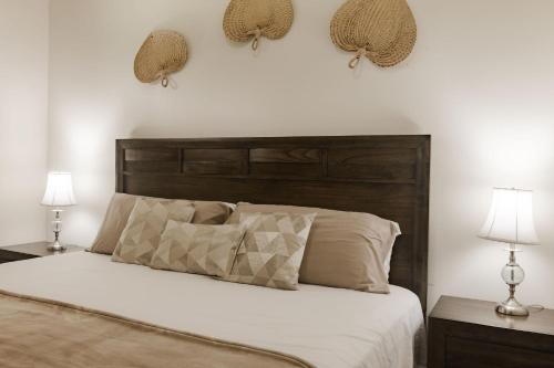 a bedroom with a bed with two lamps and two tables at Punta Chame Resort Takeover in Chame