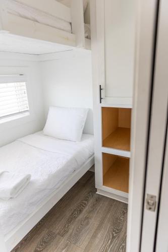a small bedroom with a bed and a closet at Oceans RV Resort in Holly Ridge