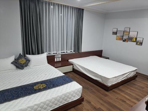 a bedroom with two beds and a window at HOÀNG GIA LUXURy in Hanoi