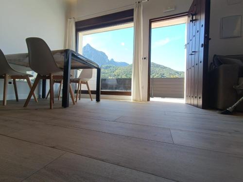 a room with a table and chairs and a large window at El Paraíso de Aitana in Ramales de la Victoria