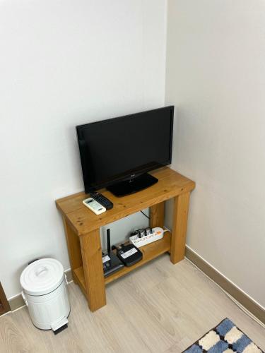 a television sitting on a wooden table in a room at Danaharu Guesthouse in Jeonju