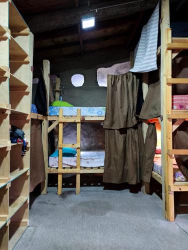 a room with two bunk beds in a house at La Casa de Barro in Puerto Natales