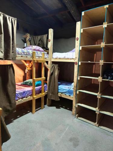 a room with two bunk beds in a room at La Casa de Barro in Puerto Natales