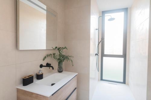 a bathroom with a sink and a mirror at Villa Golf Isla Canela Links in Ayamonte