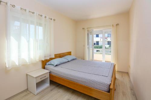 a bedroom with a bed and a window at Apartments with parking space Srima - Vodice, Vodice - 23593 in Srima