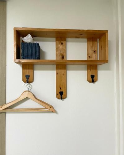a wooden shelf hanging on a wall at Danaharu Guesthouse in Jeonju