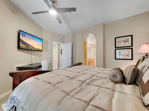 a bedroom with a large bed with a ceiling fan at Mountain View #312 Surprise in Surprise