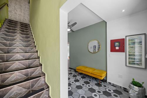 a staircase in a house with a yellow bench at La Buena Vida Inn in San Juan