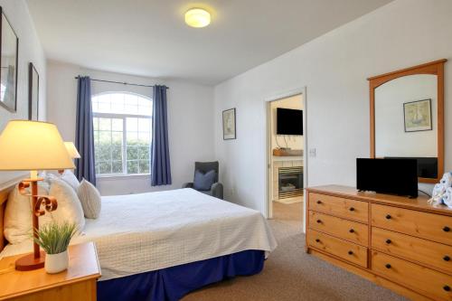 a bedroom with a bed and a dresser with a television at Pacific Plaza #305 - Shore Thing - BdrmD-K in Oceano