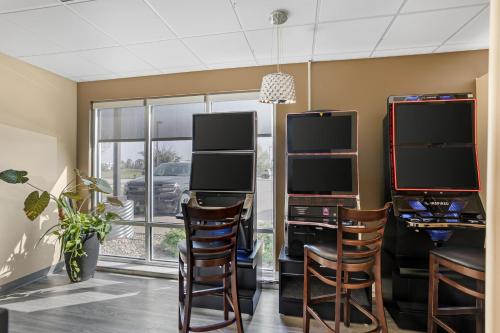 a room with two computer monitors and chairs at Best Western Plus Airport Inn & Suites in Saskatoon