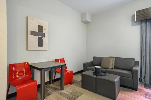 a living room with a couch and a table and chairs at Best Western Plus Airport Inn & Suites in Saskatoon