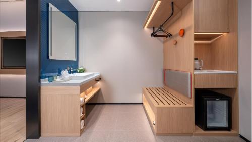 a small bathroom with a sink and a mirror at Holiday Inn Express Haikou Int'l Duty Free City by IHG in Haikou