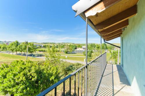 a balcony with a view of a park at Casa a Pollenzo in Santa Vittoria dʼAlba